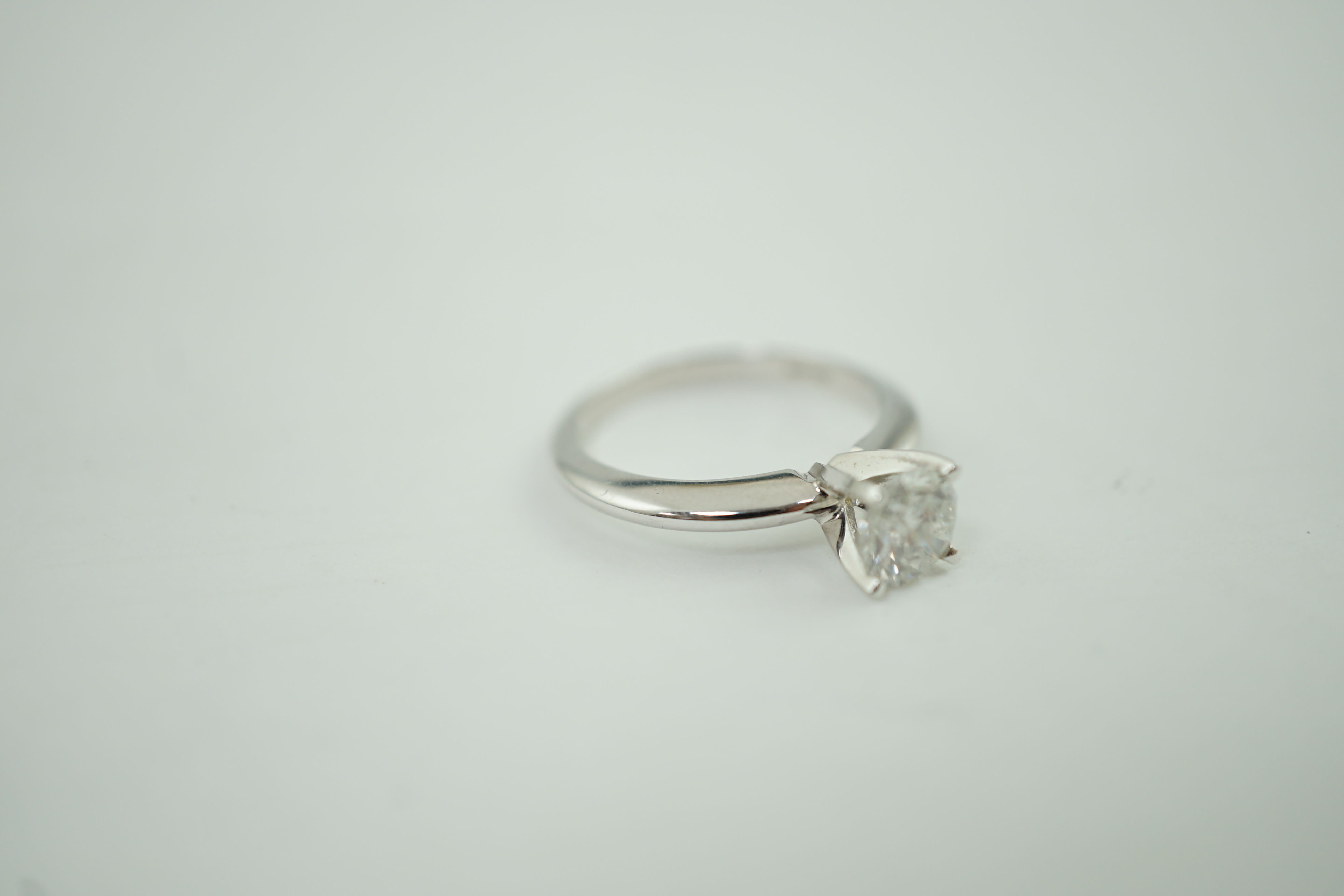 A modern 14k gold and solitaire diamond set ring